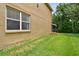 Exterior of home featuring a spacious backyard and screened lanai at 15815 Muirfield Dr, Odessa, FL 33556