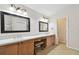 Bright bathroom featuring dual sinks, vanity and tiled floors at 15815 Muirfield Dr, Odessa, FL 33556