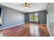 Large bedroom with hardwood floors, neutral walls, and ceiling fan at 15815 Muirfield Dr, Odessa, FL 33556