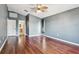 Bedroom featuring hardwood floors, ceiling fan and ensuite bath at 15815 Muirfield Dr, Odessa, FL 33556