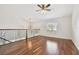 This bonus room is illuminated by natural light, and boasts attractive wood floors and stylish wrought iron railings at 15815 Muirfield Dr, Odessa, FL 33556
