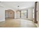 Dining room featuring tile flooring, an arched doorway, modern light fixture, and natural light at 15815 Muirfield Dr, Odessa, FL 33556