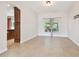 Well-lit dining area with tile floors and access to the kitchen and back patio at 15815 Muirfield Dr, Odessa, FL 33556
