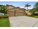 Charming home with a three-car garage, well-maintained landscaping, and a spacious driveway at 15815 Muirfield Dr, Odessa, FL 33556