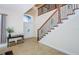 Grand foyer showcasing high ceilings, a staircase with wrought iron detailing, and a front door with transom window at 15815 Muirfield Dr, Odessa, FL 33556