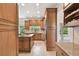 Well-appointed kitchen with wood cabinets, granite countertops, and views into the spacious living areas at 15815 Muirfield Dr, Odessa, FL 33556
