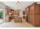 Modern kitchen with tile flooring, stainless steel appliances, and ample cabinet space, adjacent to the outdoors at 15815 Muirfield Dr, Odessa, FL 33556