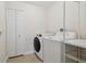 Functional laundry room equipped with washer and dryer, plus storage at 15815 Muirfield Dr, Odessa, FL 33556