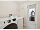 Bright laundry room with modern washer and dryer at 15815 Muirfield Dr, Odessa, FL 33556
