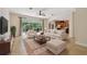 Inviting living room with a large window overlooking a pool area and an adjacent modern kitchen at 15815 Muirfield Dr, Odessa, FL 33556