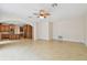 Bright and airy living room with tiled floors open to a modern kitchen at 15815 Muirfield Dr, Odessa, FL 33556