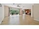Open living space with sliding glass doors to the screened-in pool, and a kitchen view at 15815 Muirfield Dr, Odessa, FL 33556