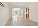 Bright open living space with tile flooring, arched doorway, and windows overlooking the front yard at 15815 Muirfield Dr, Odessa, FL 33556