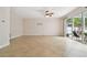 Spacious living area featuring tile floors and sliding glass doors to an outdoor patio at 15815 Muirfield Dr, Odessa, FL 33556