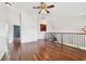 Upstairs loft area boasting hardwood floors, staircase, and neutral paint at 15815 Muirfield Dr, Odessa, FL 33556