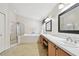 Bright main bath features a soaking tub, glass shower, and double sinks at 15815 Muirfield Dr, Odessa, FL 33556