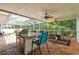 Enjoy outdoor living in this screened-in lanai with a built-in grill and comfortable seating areas at 15815 Muirfield Dr, Odessa, FL 33556