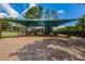 Community playground with slides, climbing structures, and shaded seating area, perfect for outdoor Gathering fun at 15815 Muirfield Dr, Odessa, FL 33556