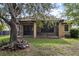 Tranquil backyard featuring a screened porch, mature trees, and lush landscaping at 20314 Chestnut Grove Dr, Tampa, FL 33647