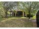 Landscaped backyard with a screened porch and mature trees providing shade and privacy at 20314 Chestnut Grove Dr, Tampa, FL 33647