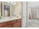 Clean bathroom featuring a single vanity, toilet, and tub with a shower, offering essential amenities at 20314 Chestnut Grove Dr, Tampa, FL 33647