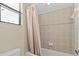 Well-lit bathroom featuring a tub with tile surround and neutral-colored shower curtain at 20314 Chestnut Grove Dr, Tampa, FL 33647