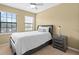 Comfortable bedroom with a ceiling fan, a large window, and a nightstand next to the bed at 20314 Chestnut Grove Dr, Tampa, FL 33647