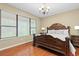 A bedroom with a king size bed, nice hardwood floors and great light at 20314 Chestnut Grove Dr, Tampa, FL 33647