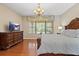 Comfortable bedroom with an ornate dresser, chandelier, and view to the outdoors at 20314 Chestnut Grove Dr, Tampa, FL 33647