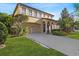 Charming two-story home featuring a two-car garage and lush landscaping at 20314 Chestnut Grove Dr, Tampa, FL 33647