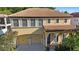 Charming two-story home featuring a terracotta roof, arched entryway, and a two-car garage at 20314 Chestnut Grove Dr, Tampa, FL 33647