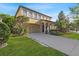 Charming two-story home featuring a two-car garage and lush landscaping at 20314 Chestnut Grove Dr, Tampa, FL 33647