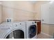 Functional laundry room with washer, dryer, and shelving at 20314 Chestnut Grove Dr, Tampa, FL 33647
