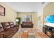 Spacious living area with plush sofas, a fireplace, and a staircase leading to the upper level at 20314 Chestnut Grove Dr, Tampa, FL 33647