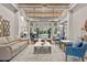 Luxurious lounge area with stylish sofas, elegant decor, and large windows overlooking the pool area at 20314 Chestnut Grove Dr, Tampa, FL 33647