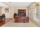 Office space with a wooden desk, hutch, and tile flooring, bathed in natural light from nearby windows at 20314 Chestnut Grove Dr, Tampa, FL 33647