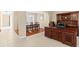 Open office space with dark wood desk and shelving adjacent to dining area with wood floors at 20314 Chestnut Grove Dr, Tampa, FL 33647
