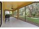 An outdoor patio boasts a ceiling fan and views of the backyard and beyond at 20314 Chestnut Grove Dr, Tampa, FL 33647