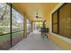 The screened lanai area includes a ceiling fan and backyard view at 20314 Chestnut Grove Dr, Tampa, FL 33647