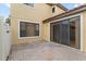 A brick patio with sliding glass doors leads to the residence at 20314 Chestnut Grove Dr, Tampa, FL 33647