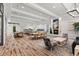 Bright and open recreation room with dining tables, a fireplace, and a view of the kitchen area at 20314 Chestnut Grove Dr, Tampa, FL 33647