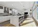 Modern kitchen featuring a large island, stainless steel appliances, mosaic backsplash, and bright natural light at 21 Crescent S Pl, St Petersburg, FL 33711