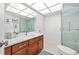 Modern bathroom featuring a wood vanity, quartz countertop, and glass enclosed shower with tile surround at 7233 15Th Ne Ct, St Petersburg, FL 33702