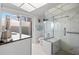 Modern bathroom with glass enclosed shower, mosaic floor, sleek vanity and access to outdoor patio at 7233 15Th Ne Ct, St Petersburg, FL 33702