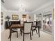 Elegant dining room with a chandelier and sliding glass doors to an outdoor patio at 7233 15Th Ne Ct, St Petersburg, FL 33702