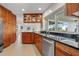 Spacious kitchen with wooden cabinets, stainless steel appliances, and black countertops at 7233 15Th Ne Ct, St Petersburg, FL 33702