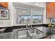 Kitchen sink with window overlooking screened-in lanai with lake views at 7233 15Th Ne Ct, St Petersburg, FL 33702