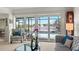 Bright living room with sliding glass doors leading to a screened pool and water view at 7233 15Th Ne Ct, St Petersburg, FL 33702