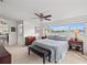 Bright main bedroom with ceiling fan, chest, bench and picturesque water views from the large window at 7233 15Th Ne Ct, St Petersburg, FL 33702