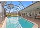 Swimming pool with screened enclosure and outdoor seating area at 7233 15Th Ne Ct, St Petersburg, FL 33702